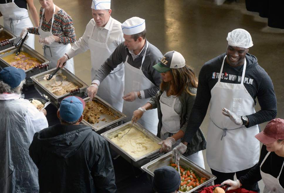 Al Hartmann  |  The Salt Lake Tribune
Some 200 volunteers help serve up to 4,000 hot traditional Thanksgiving meals to local homeless and low income individuals at the The 18th annual "We Care - We Share" at the  Vivint Smart Home Arena Monday, Nov. 21.  This event is part of the NBA Cares Season of Giving. 
It was in In collaboration with the Salt Lake City Mission, Utah Food Services, All-Star Catering, the Miller family and Larry H. Miller Sports & Entertainment.   employees will serve a warm, traditional Thanksgiving meal to thousands of residents in need. 
The annual gathering will also had winter clothing distribution, musical entertainment courtesy of the Salt Lake City Mission and activity packets for children.